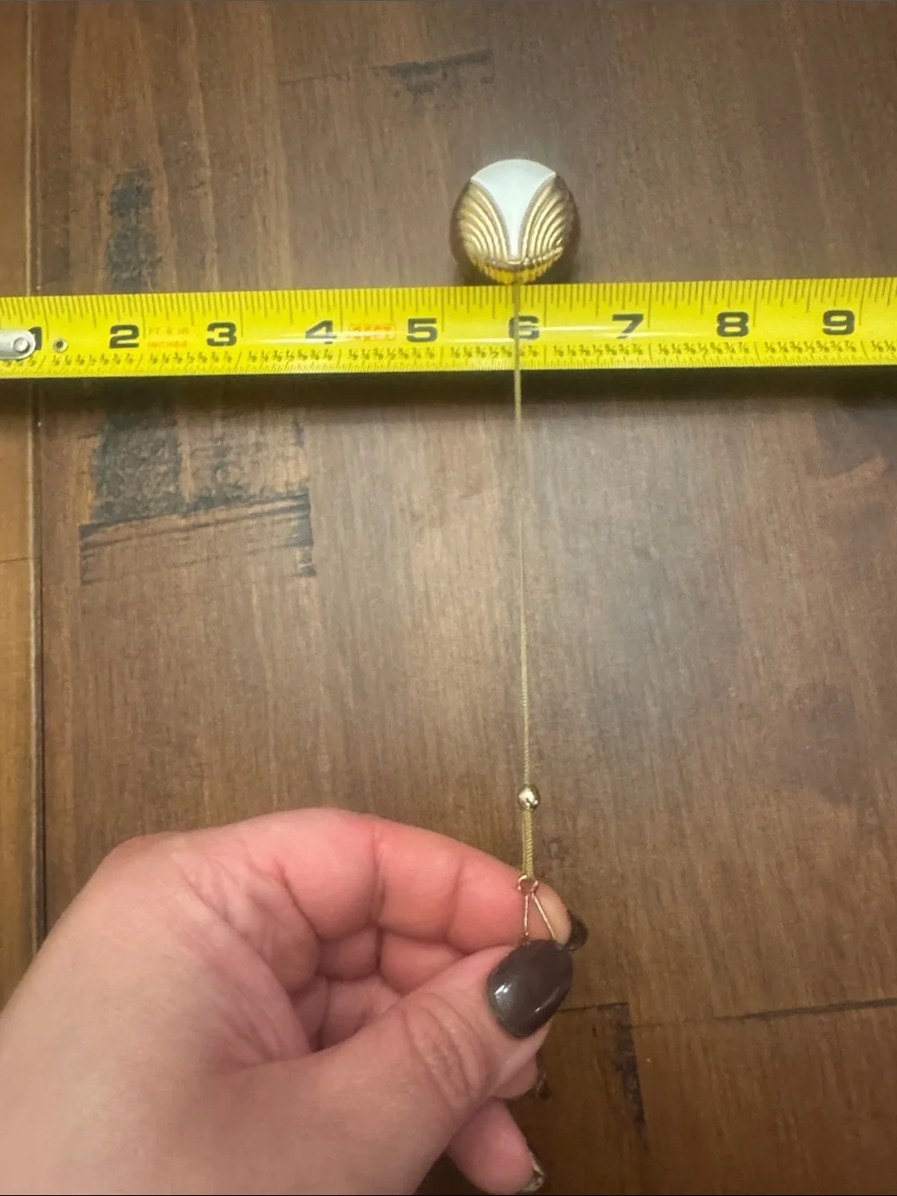 Vintage Avon Gold and White Shielded Badge Reel-retractable gold pull never used